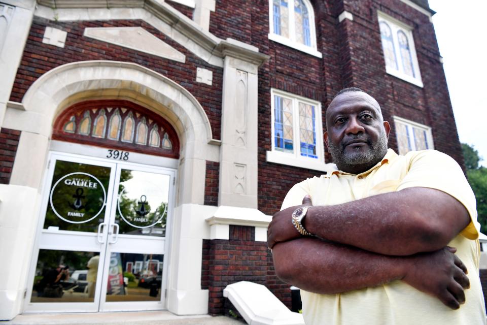 Pastor Eric Johnson, shown outside Greater Galilee Baptist, runs a program that works with students throughout the year. For Christmas, his staff raised enough money to give about a dozen a Christmas full of presents - bikes, dolls, shoes, clothes.