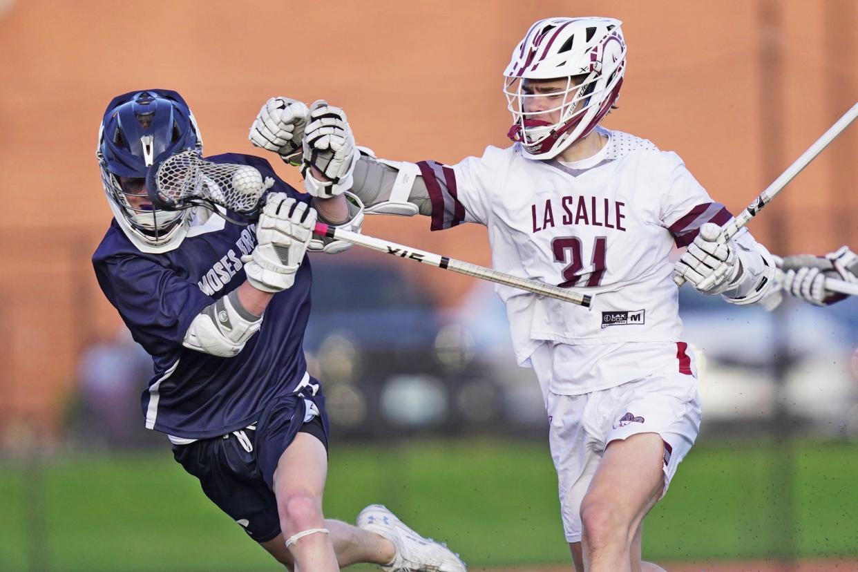 La Salle's Quinn Peterson delivers a hit to Will Carosi during the first quarter of Tuesday's rivalry game that was close for seven minutes before the Rams ran away with things in the 22-5 win.