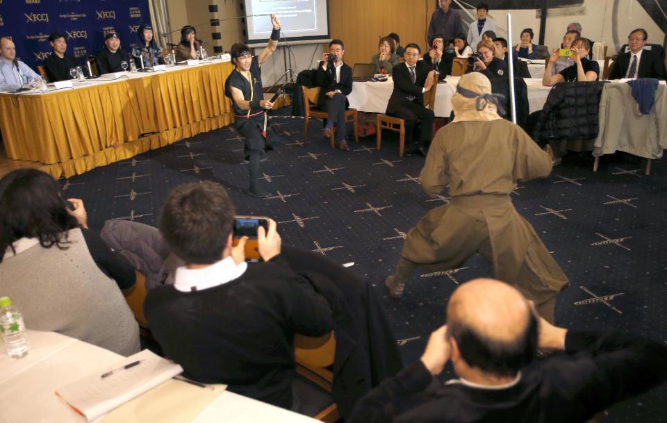 Members of Iga ninja group Ashura demonstrate a ninja-inspired martial-art during a press conference by the Japan Ninja Council at Foreign Correspondents' Club of Japan in Tokyo, Wednesday, Feb. 22, 2017. The Japan Ninja Council, a government-backed organization of scholars, tourism groups and businesses, said that it's starting a Ninja Academy to train people in the art of ninja, and building a new museum in Tokyo devoted to ninja, hooded samurai-era acrobatic spies, set to open in 2018. (AP Photo/Shizuo Kambayashi)