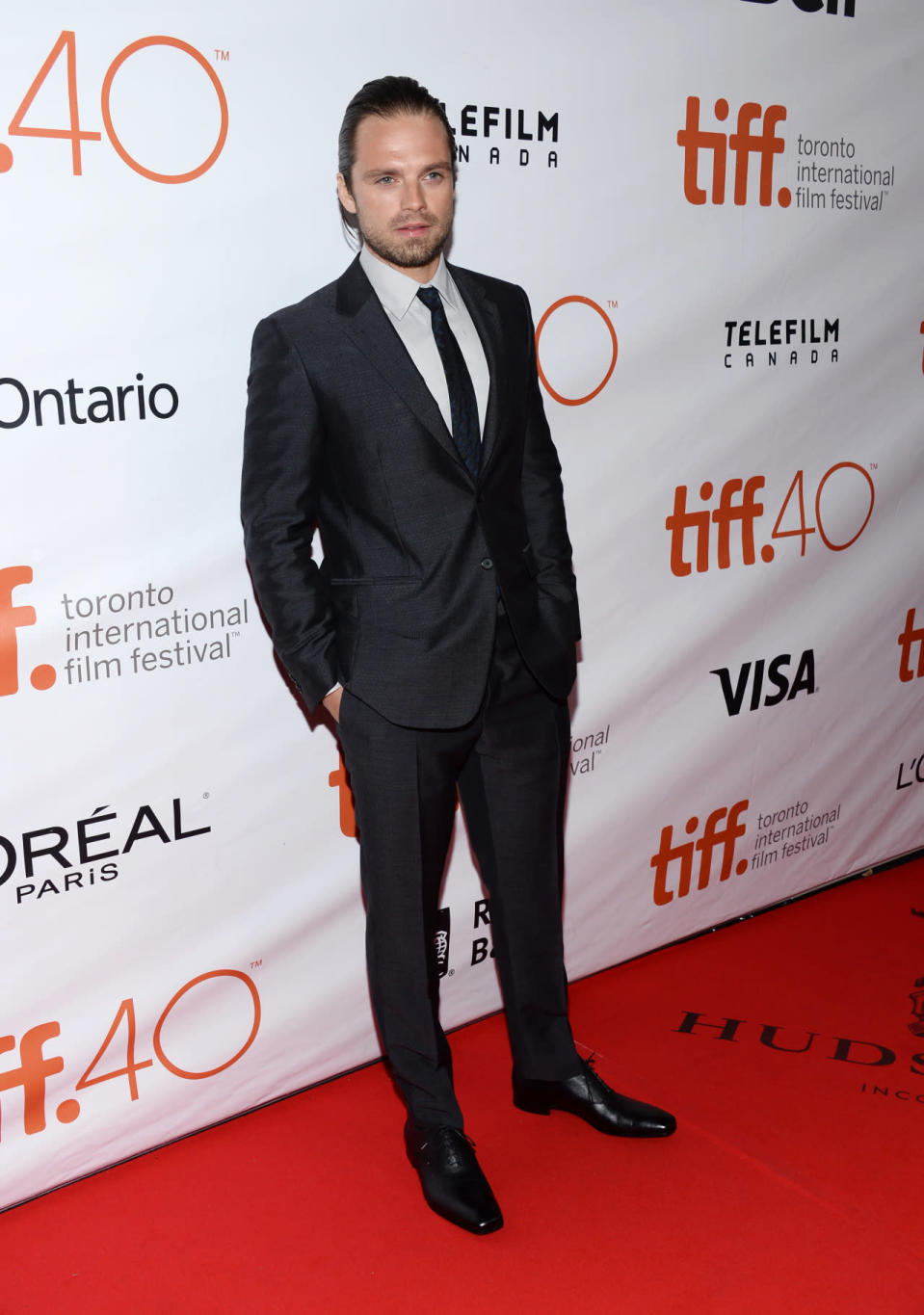 <p>With his hair pushed back, doesn’t Sebastian Stan look sexy in a dark gray suit with black velvet lapels and black matte shoes? </p>