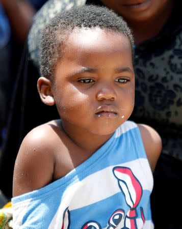 A migrant child sits at a naval base after being rescued by Libyan coast guards in Tripoli, Libya June 29, 2018. REUTERS/Ismail Zitouny