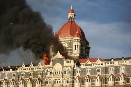 Smoke rises from the Taj Mahal Hotel in Mumbai in this November 27, 2008 file photo. REUTERS/Punit Paranjpe