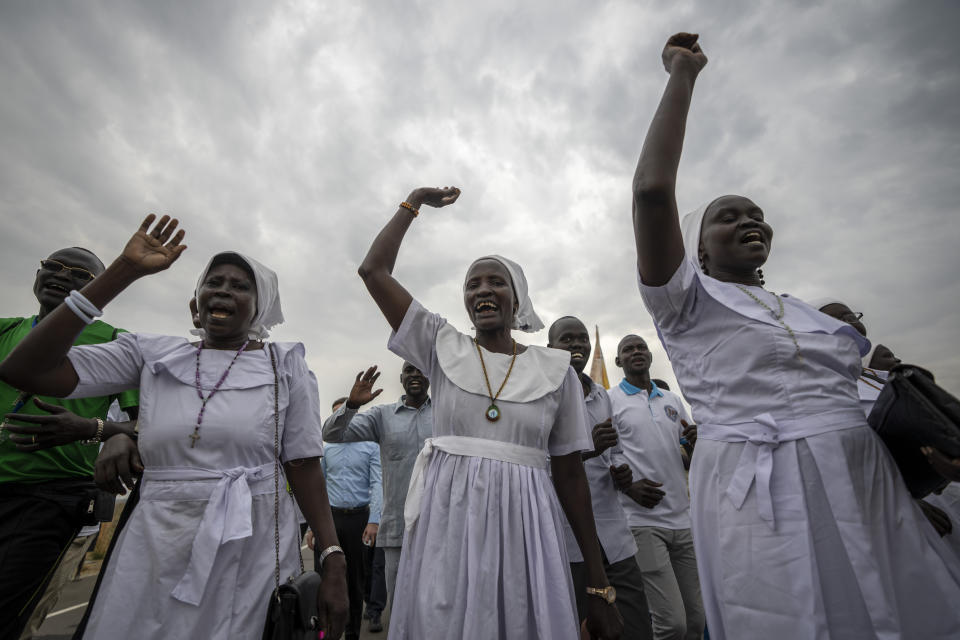 A group of the Catholic faithful from the town of Rumbek cheer as they arrive after walking for more than a week to reach the capital for the visit of Pope Francis, in Juba, South Sudan Thursday, Feb. 2, 2023. Pope Francis is due to travel to South Sudan later this week on the second leg of a six-day trip that started in Congo, hoping to bring comfort and encouragement to two countries that have been riven by poverty, conflicts and what he calls a "colonialist mentality" that has exploited Africa for centuries. (AP Photo/Ben Curtis)