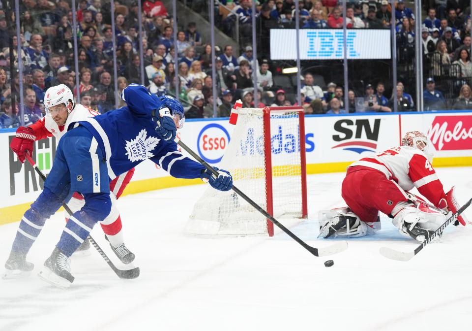 Maple Leafs center Auston Matthews battles for the puck with Red Wings defenseman Ben Chiarot during the first period on Saturday, April 13, 2024, in Toronto.