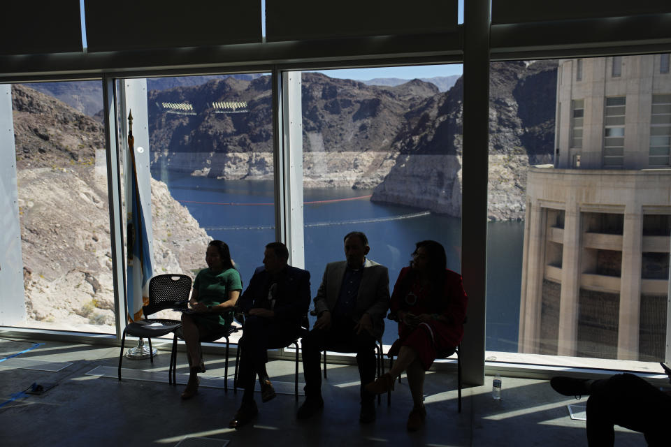 Officials listen during a news conference on Lake Mead at Hoover Dam, Tuesday, April 11, 2023, near Boulder City, Nev. The Biden administration on Tuesday released an environmental analysis of competing plans for how Western states and tribes reliant on the dwindling Colorado River should cut their use. (AP Photo/John Locher)