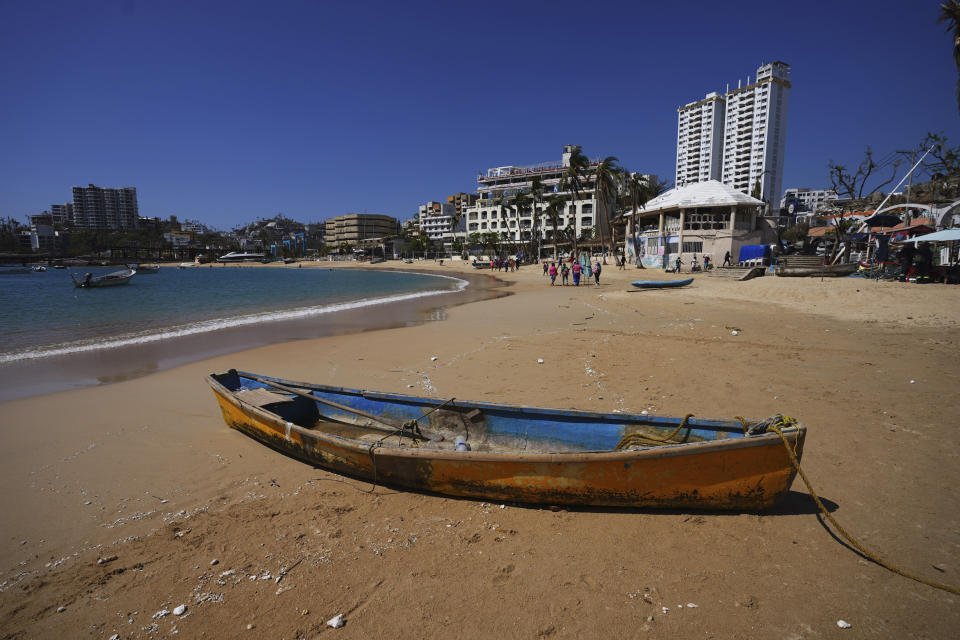 A boat lays on the shore weeks after the passing of Hurricane Otis in Acapulco, Mexico, Sunday, Nov. 12, 2023. It was 12:20 a.m. on Oct. 25. when Hurricane Otis made landfall in this Pacific port city as a Category 5 hurricane, leaving 48 dead, mostly by drowning, and 31 missing, according to official figures. Sailors, fishermen and relatives of crew members believe that there may be more missing because sailors often go to take care of their yachts when a storm approaches. (AP Photo/Marco Ugarte)