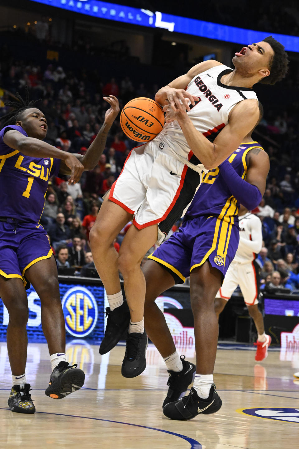 Georgia guard Jabri Abdur-Rahim (1) loses the ball as LSU guard Cam Hayes (1) aand KJ Williams, right, defend during the second half of an NCAA college basketball game in the first round of the Southeastern Conference tournament, Wednesday, March 8, 2023, in Nashville, Tenn. LSU won 72-67. (AP Photo/John Amis)