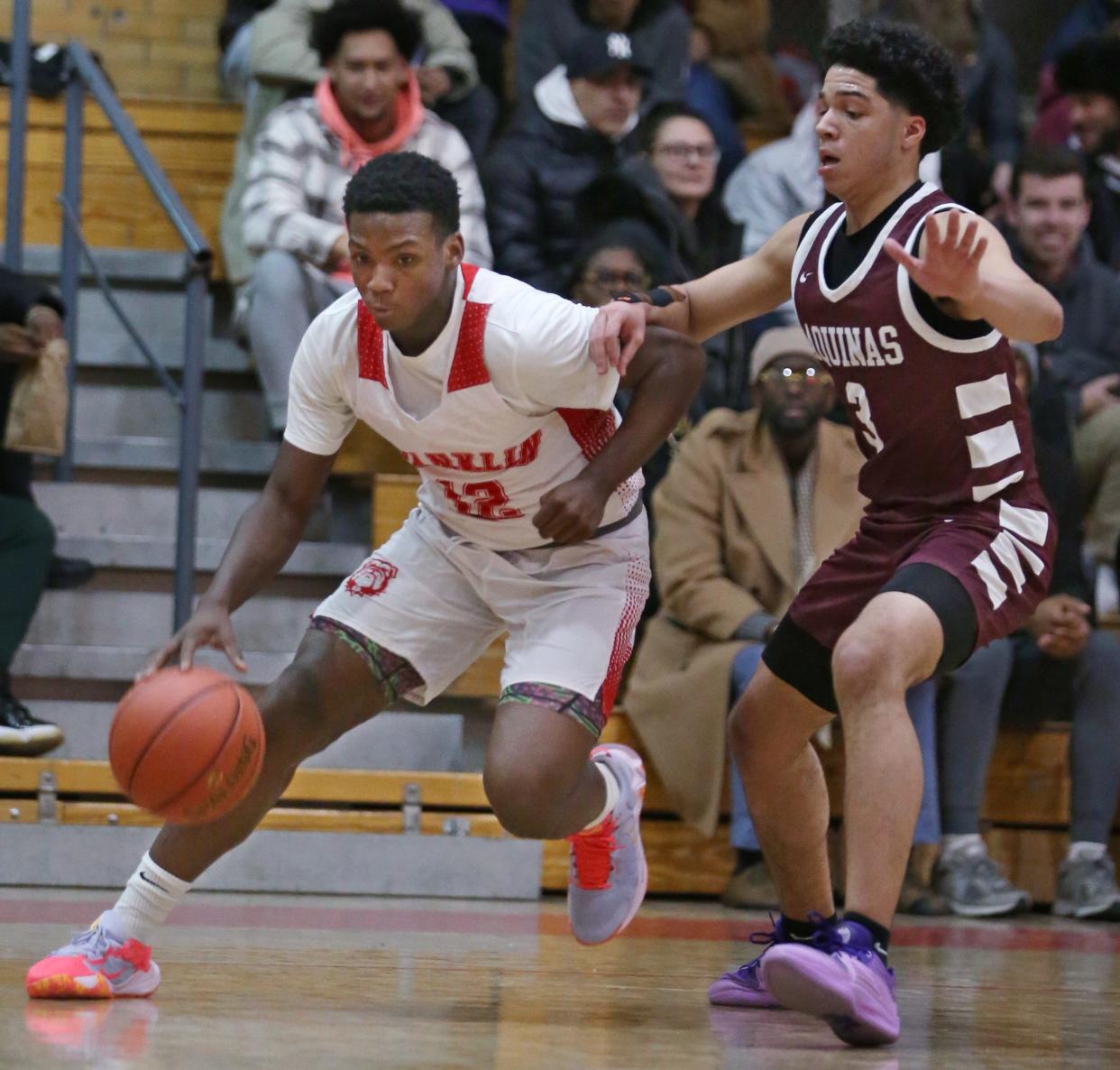 Franklin's Curtis Bell drives the baseline past Aquinas's Mackie Terry.