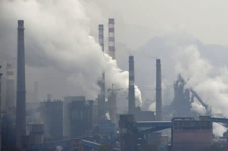 Smoke rises from chimneys and facilities of steel plants in Benxi, Liaoning province November 3, 2013. REUTERS/Stringer/File Photo