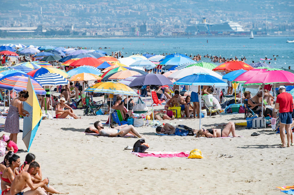 Lots of bathers under umbrellas at the 'playa', the city's sandy beach, to find refreshment on a scorching hot Sunday with a maximum alert level for high temperatures  on July 16, 2023 in Catania, Italy. The record for the highest temperature in European history was broken in August 2021, when 48.8C was registered in Floridia, a town in Italy's Sicilian province of Syracuse. / Credit: Getty Images