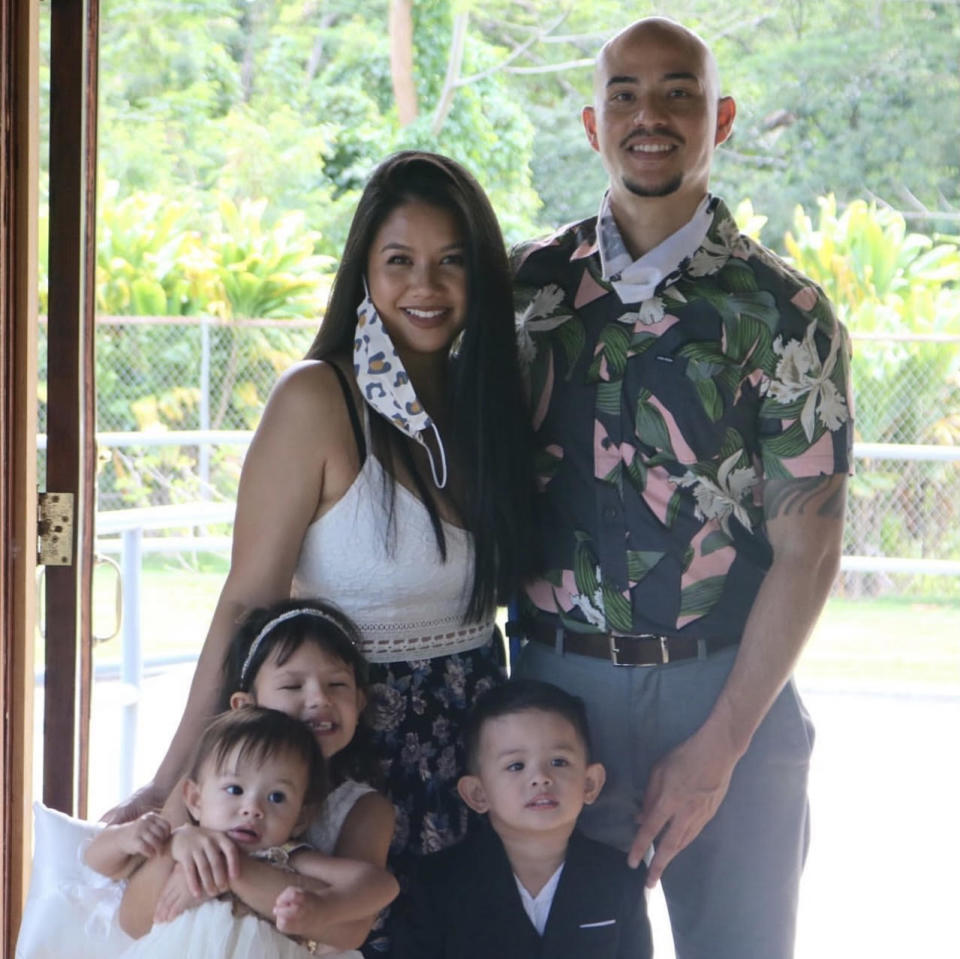 Casey posing for a photo with her husband and three kids