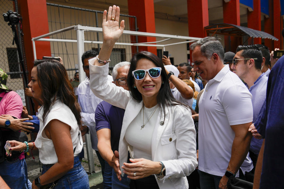 Presidential candidate Luisa González, of the Citizen's Revolution Political Movement, waves upon her arrival to a polling station in Guayaquil, Ecuador, Sunday, Aug. 20, 2023. The election was called after President Guillermo Lasso dissolved the National Assembly by decree in May to avoid being impeached. (AP Photo/Martin Mejia)