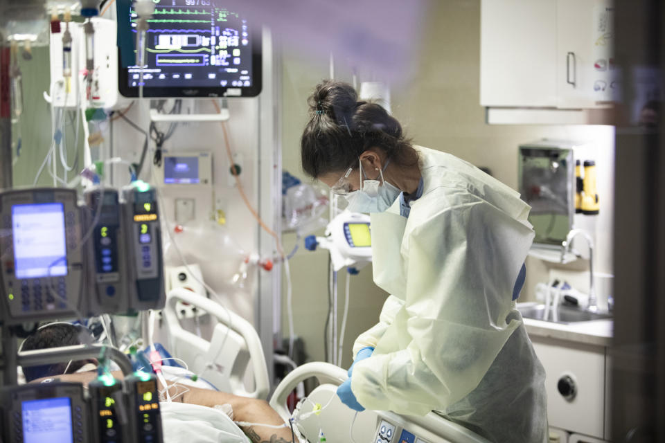 Ann Enderle, R.N., checks on a COVID-19 patient in the Medical Intensive care unit (MICU) at St. Luke's Boise Medical Center in Boise, Idaho on Tuesday, Aug. 31, 2021. There are only 4 open ICU beds available in all of Idaho as of Tuesday. (AP Photo/Kyle Green)