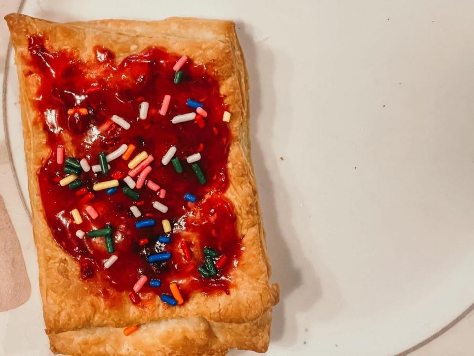 toaster pastry topped with berry icing and rainbow sprinkles