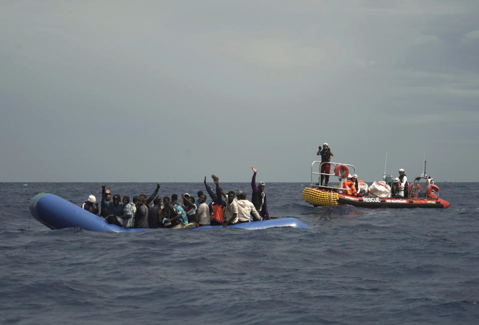 Migrants are seen waving after being found some 14 nautical miles from the coast of Libya in Mediterranean Sea, Sunday, Sept. 8, 2019. Humanitarian groups SOS Mediterranee and Doctors Without Borders have successfully rescued 50 migrants and brought them aboard the Ocean Viking. (AP Photo/Renata Brito)