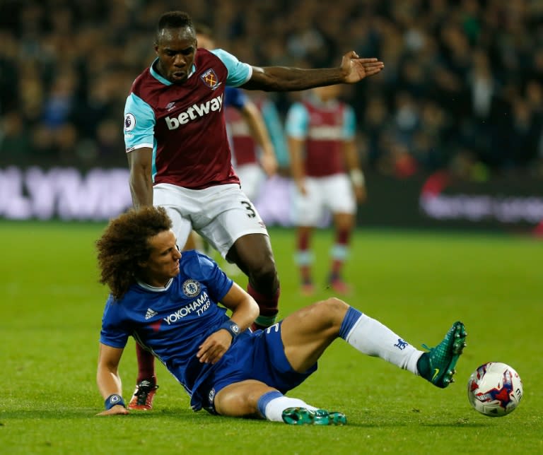 West Ham's English midfielder Michail Antonio is tackled by Chelsea's Brazilian defender David Luiz (L) during the EFL Cup game in east London on October 26, 2016