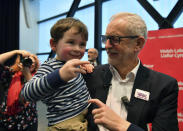 Labour Leader Jeremy Corbyn interacts with three years old Noa Williams Roberts after addressing a members' rally at Bangor University, while on the General Election campaign trail in Bangor, Wales, Sunday, Dec. 8, 2019. Britain goes to the polls on Dec. 12. (Ben Birchall/PA via AP)