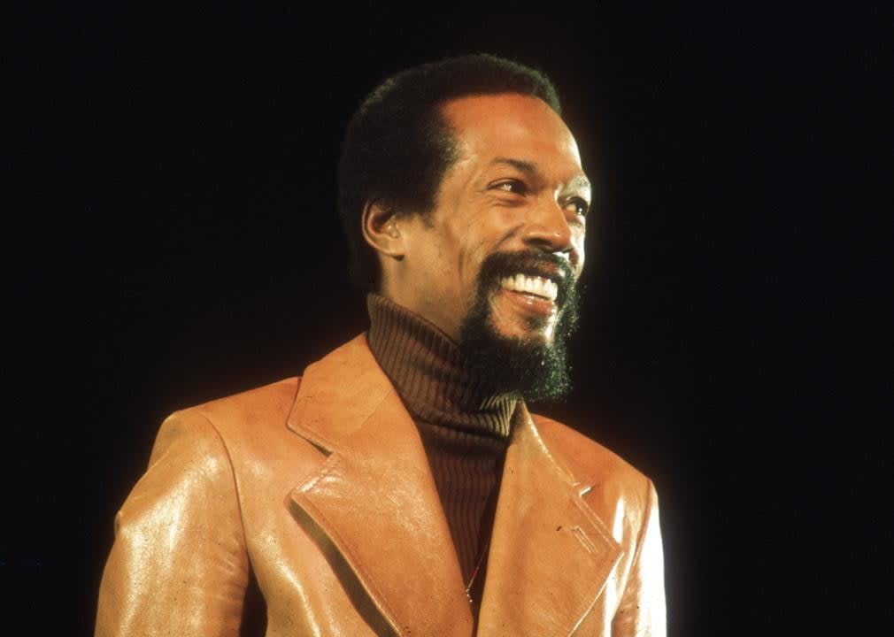 Eddie Kendricks smiling on black background.