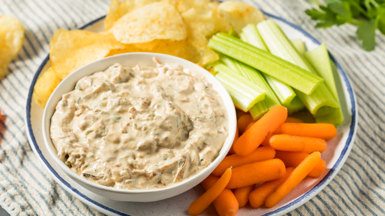 onion dip in bowl with veggies and chips