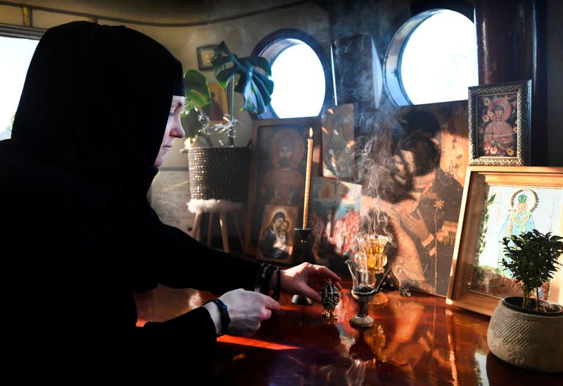 A nun burns a piece of incense stick at the livingroom of a mobile Georgian Orthodox monastery in Vlissingen