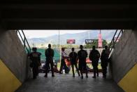 Police officers watch a baseball game at University Stadium in Caracas