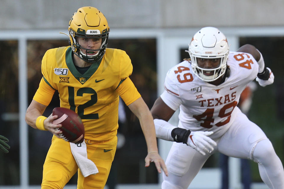 Baylor quarterback Charlie Brewer (12) runs the ball against Texas in the third quarter in an NCAA college football game Saturday, Nov. 23, 2019, in Waco, Texas. (AP Photo/Richard W. Rodriguez)