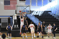 Worcester Polytechnic Institute center Logan O'Donnell (32) goes to the basket for a layup against Yeshiva guard Max Leibowitz (1) during the second half of an NCAA DIII college basketball game that allowed no spectators on Friday, March 6, 2020, in Baltimore, Md. The game at Johns Hopkins University is believed to be the first U.S. sports event held without fans because of the new coronavirus. (AP Photo/Terrance Williams)