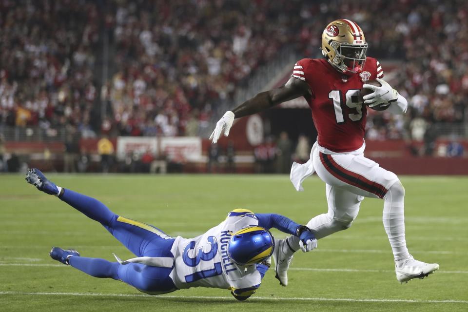 San Francisco 49ers receiver Deebo Samuel (19) runs past Rams cornerback Robert Rochell for a touchdown.