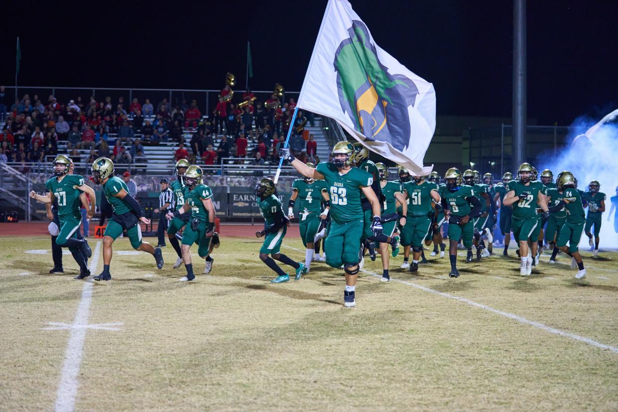 The Basha football team take the field to play Liberty at Basha High School in Chandler, Ariz. on Friday, Nov. 26, 2021.