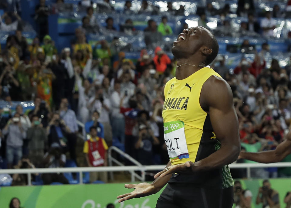 Usain Bolt from Jamaica celebrates after crossing the line to win the gold medal in the men's 200-meter final. (AP)