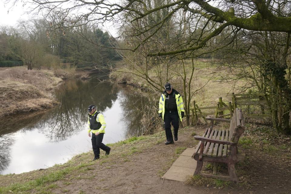 Police activity near the bench by the River Wyre in St Michael’s on Wyre, Lancashire, where Ms Bulley’s mobile phone was found (PA)