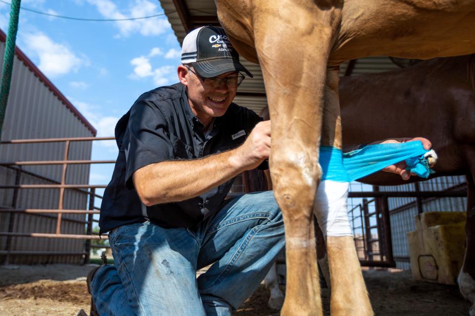 Dr. Jacob Mendenhall, an Oklahoma City oral and maxillofacial surgeon, cares for a horse on his ranch.