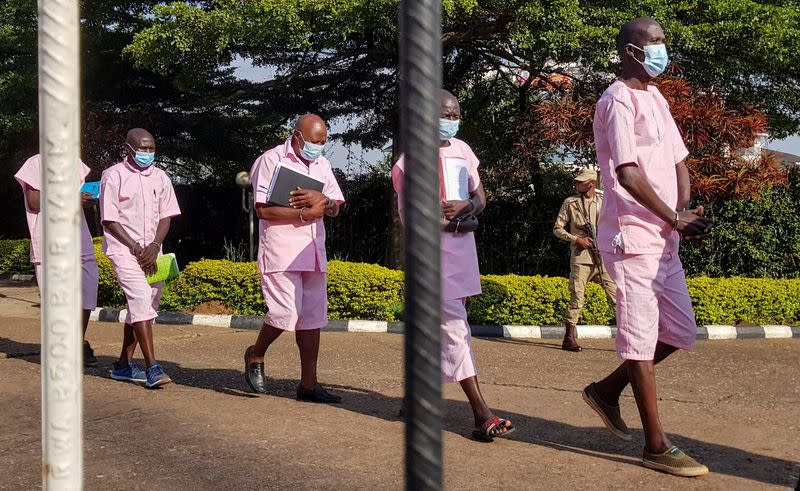 Paul Rusesabagina, portrayed as a hero in a Hollywood movie about Rwanda's 1994 genocide, walks among suspects outside the courtroom in Kigali