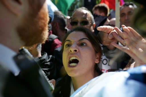 Demonstrators remonstrate with police during a protest against Turkey's President Recep Tayyip Erdogan outside the entrance to Downing Street in central London ahead of his meeting with British Premier Theresa May