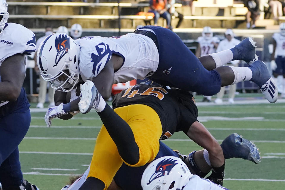 UTSA running back Sincere McCormick (3) dives over Southern Mississippi linebacker Averie Habas (46) for a short yardage touchdown during the second half of an NCAA college football game, Saturday, Nov. 21, 2020, in Hattiesburg, Miss. UTSA won 23-20. (AP Photo/Rogelio V. Solis)