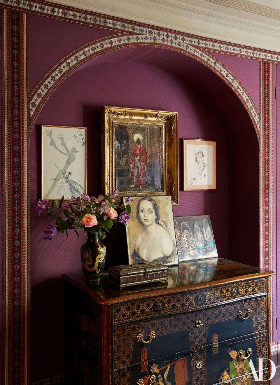 A niche in the bedroom holds artworks by Cecil Beaton, Christian Bérard, Lila de Nobili, and Anh Duong. 19th-century French cabinet with Japanese-style lacquer.