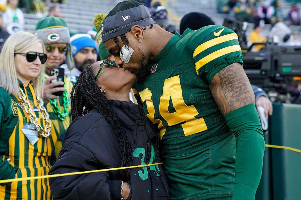 <p>Patrick McDermott/Getty Images</p> Simone Biles kisses husband Jonathan Owens at Green Bay Packers game on Nov. 19