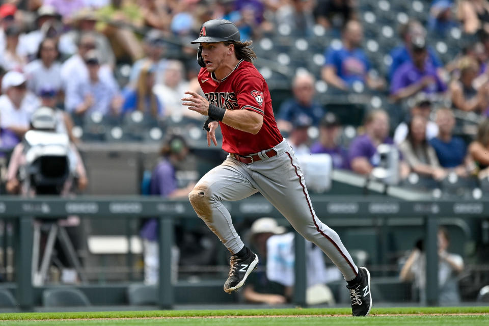 DENVER, CO - AUGUST 14: Jake McCarthy #30 of the Arizona Diamondbacks runs to score on a fourth inning sacrifice fly ball against the Colorado Rockies at Coors Field on August 14, 2022 in Denver, Colorado. (Photo by Dustin Bradford/Getty Images)