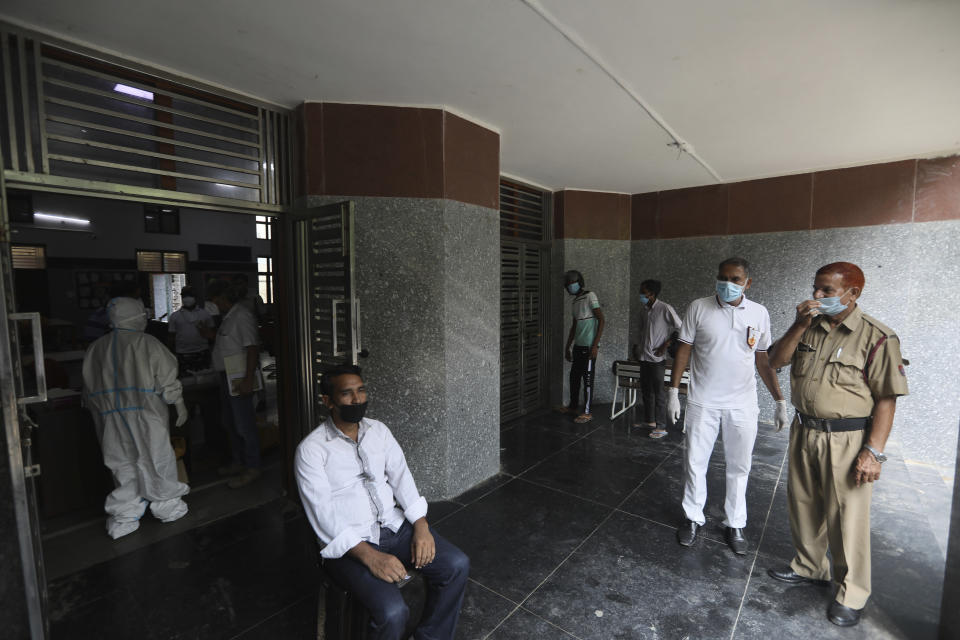 A person waits for his Covid-19 test in New Delhi, India, Monday, Sept. 7, 2020. India's coronavirus cases are now the second-highest in the world and only behind the United States, as the caseload crosses Brazil on a day when urban metro trains partially resume service in the capital New Delhi and other states. (AP Photo/Manish Swarup)