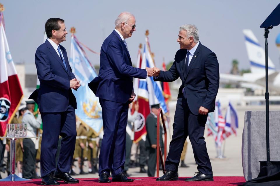 President Joe Biden fist bumps with Israeli Prime Minister Yair Lapid after Biden arrived in Tel Aviv on July 13, 2022.