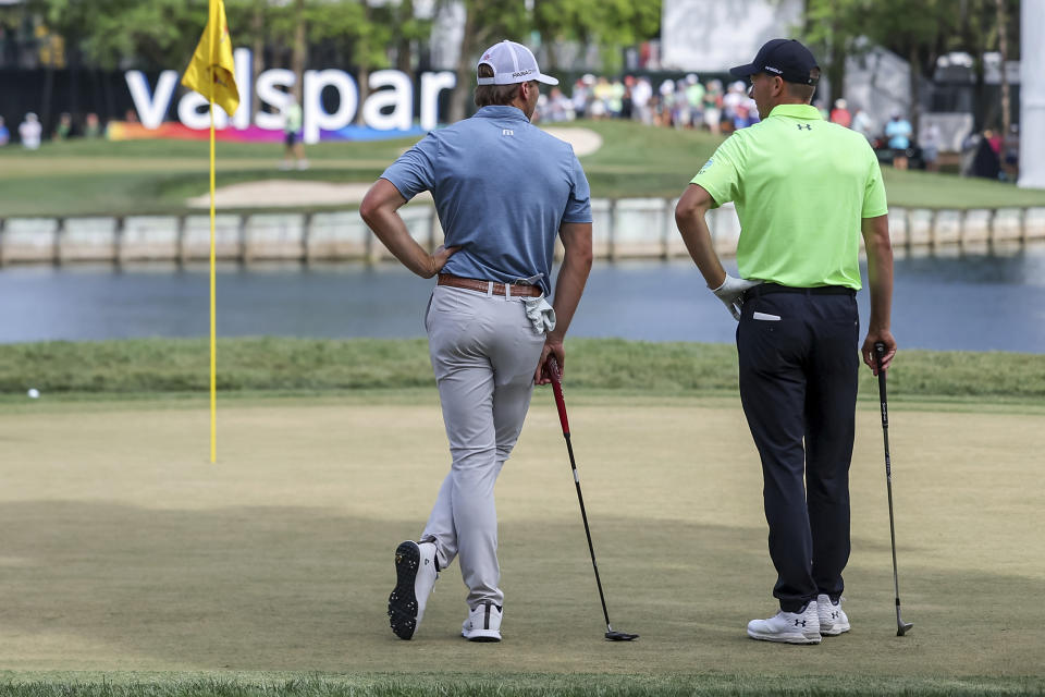Sam Burns, left, talks with Jordan Spieth on the 12th green during the second round of the Valspar Championship golf tournament Friday, March 17, 2023, at Innisbrook in Palm Harbor, Fla. (AP Photo/Mike Carlson)
