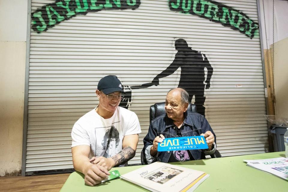 Cheech Marin of Cheech & Chong fame signs memorabilia for Jack Nguyen at Jayden’s Journey cannabis dispensary during Epilepsy Awareness Day in Modesto, Calif., on Friday, March 25, 2022.