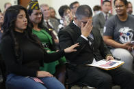 Deported veteran Mauricio Hernandez Mata, right, reacts alongside his wife, Azucena Alcantar, left, before being sworn in as a U.S. citizen at a special naturalization ceremony on Wednesday, Feb. 8, 2023, in San Diego. Hernandez Mata and Leonel Contreras, both U.S. Army veterans who were deported to Mexico a decade ago, won their long battle to return to the United States and become U.S. citizens. (AP Photo/Gregory Bull)