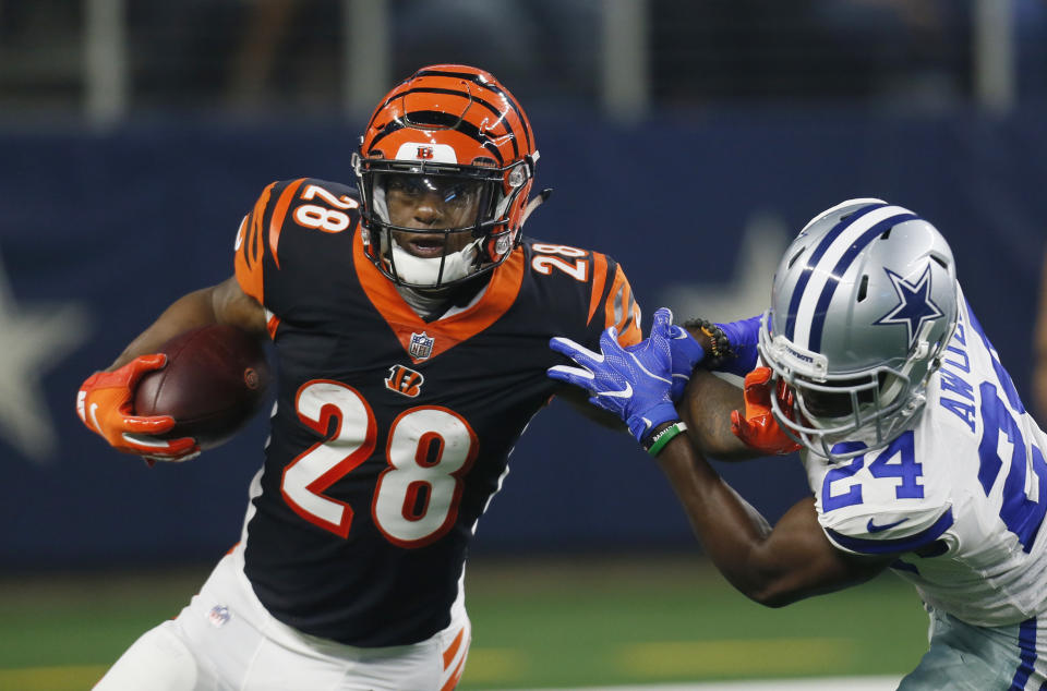 Cincinnati Bengals running back Joe Mixon (28) runs around Dallas Cowboys cornerback Chidobe Awuzie (24) during the first half of a preseason NFL football game in Arlington, Texas, Saturday, Aug. 18, 2018. (AP Photo/Roger Steinman)