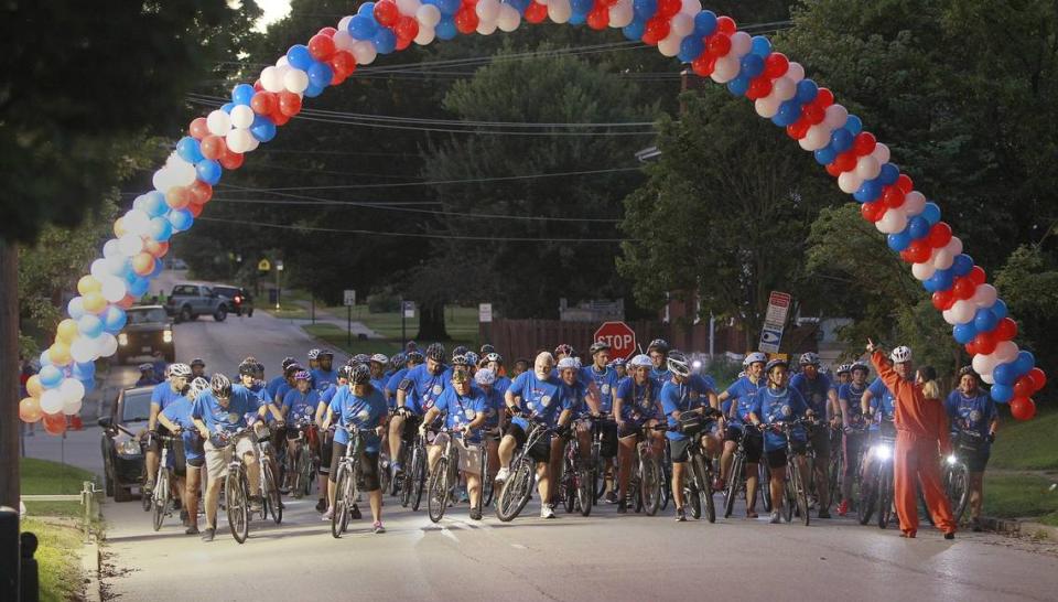 Bicyclists pass through a giant balloon arch at the start of Tour de Belleville in 2016, when about 2,000 bicyclists participated. Some wore alien costumes or space gear for the “Fly Me to the Moon” theme.