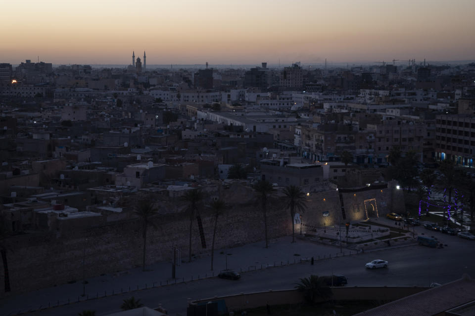 In this Feb. 29, 2020 photo, the walls surrounding the Old City are illuminated before sunrise in Tripoli, Libya. The country has been plunged into chaos since 2011, when a civil war toppled longtime dictator Moammar Gadhafi, who was later killed. (AP Photo/Felipe Dana)