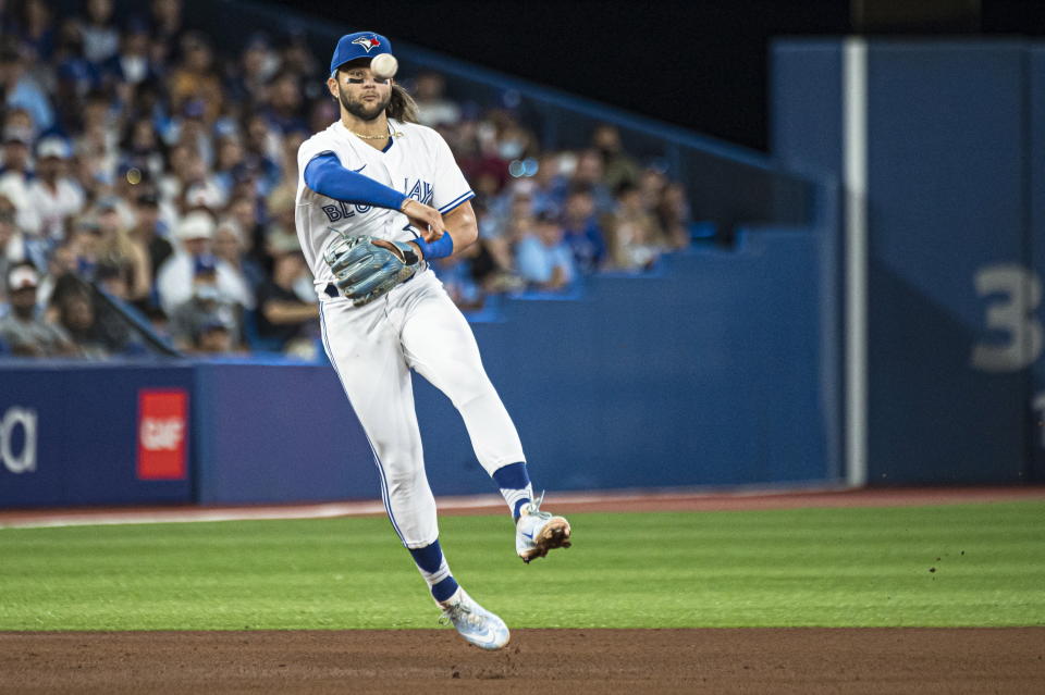 Toronto Blue Jays shortstop Bo Bichette (11) throws out Baltimore Orioles left fielder Ryan McKenna (26) at first base during the fifth inning of a baseball game in Toronto on Wednesday, Aug. 17, 2022. (Christopher Katsarov/The Canadian Press via AP)