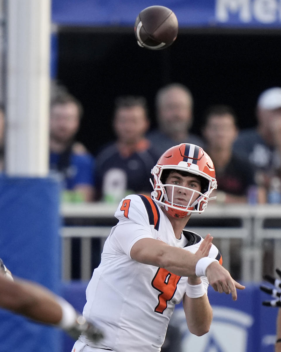 Illinois quarterback Luke Altmyer passes the ball during the first half of an NCAA college football game against Kansas Friday, Sept. 8, 2023, in Lawrence, Kan. (AP Photo/Charlie Riedel)