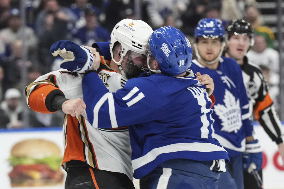 Anaheim Ducks' Radko Gudas, left, fights with Toronto Maple Leafs' Max Domi during the first period of an NHL hockey game, Saturday, Feb. 17, 2024 in Toronto. (Chris Young/The Canadian Press via AP)