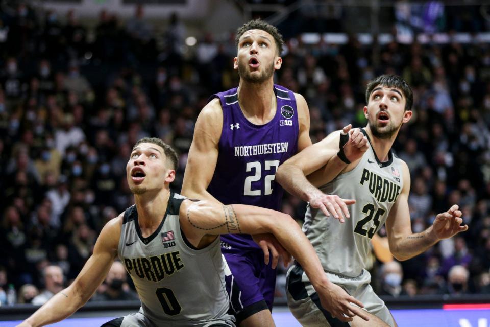 Northwestern forward Pete Nance works against Purdue’s Mason Gillis, left, and Ethan Morton, right, for rebounding position during a game in January.